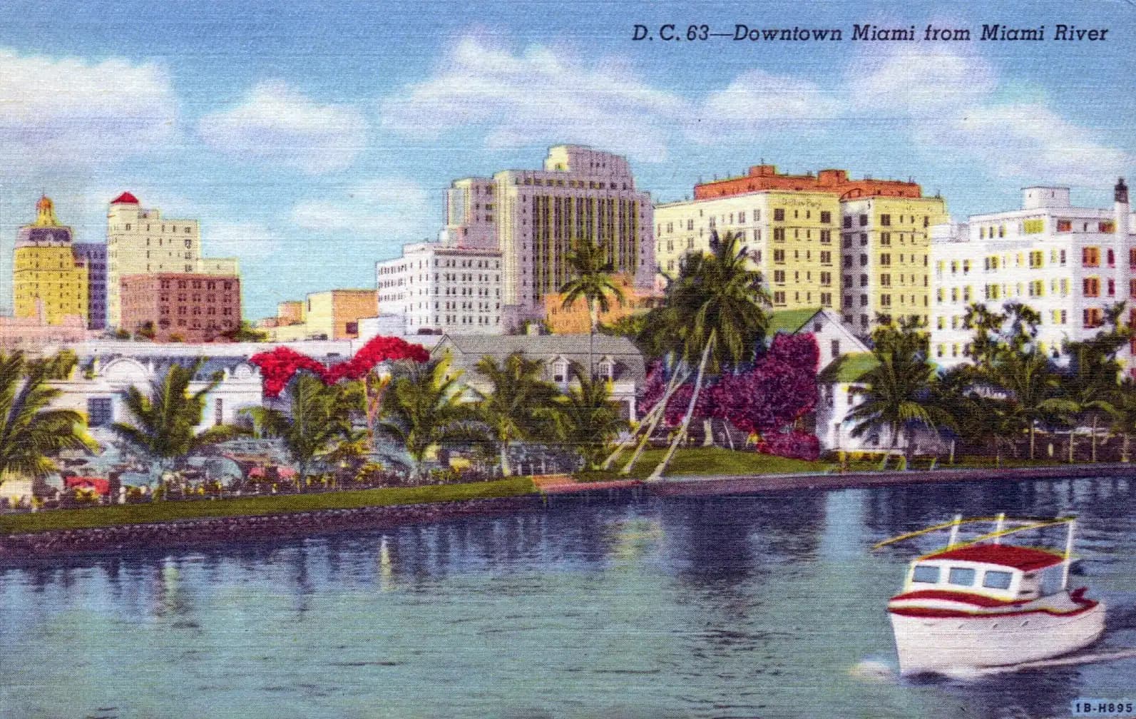 A dense cluster of downtown towers seen across water at the end of the day
