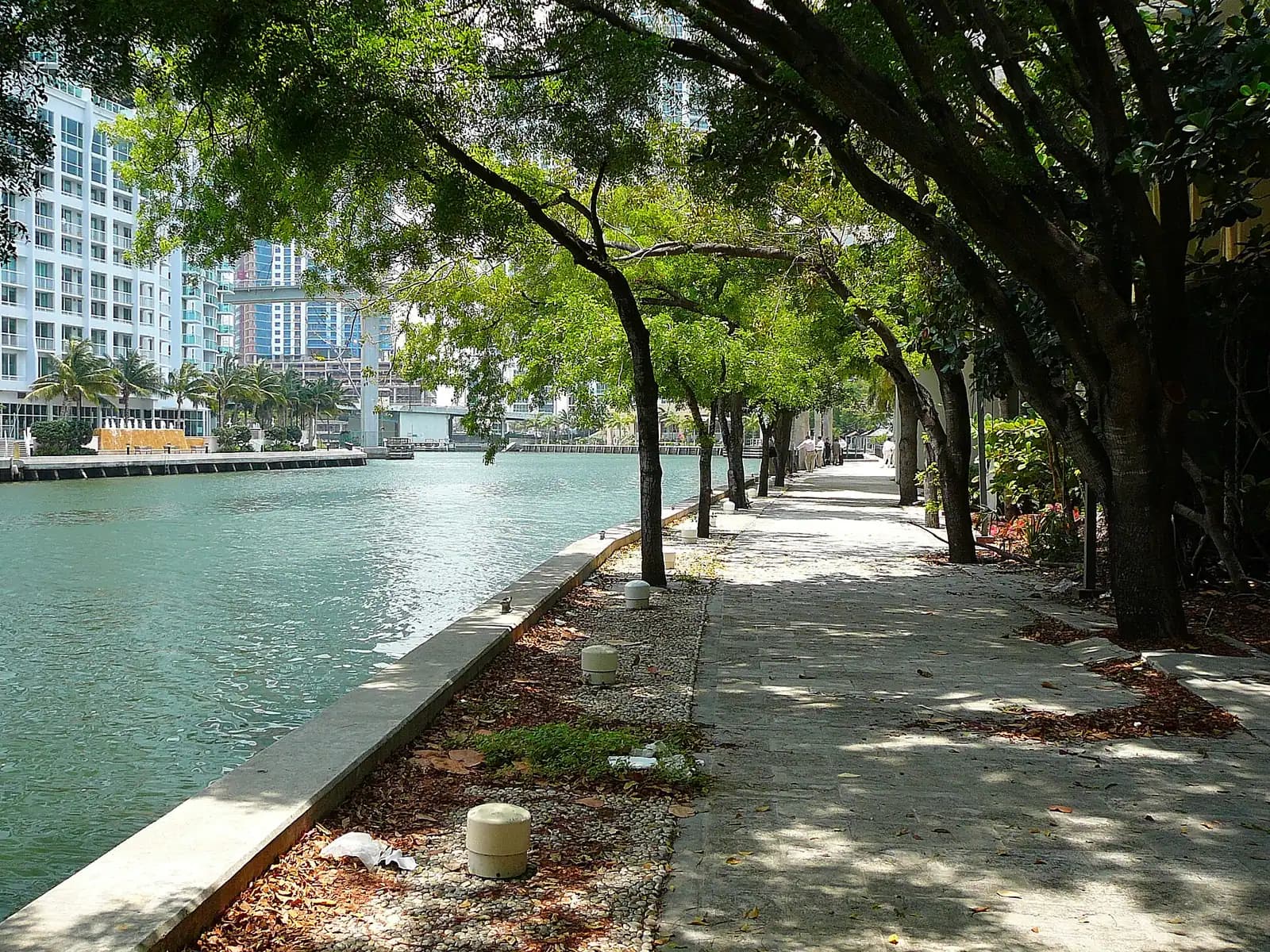 A narrow urban river running between city towers with a drawbridge crossing it