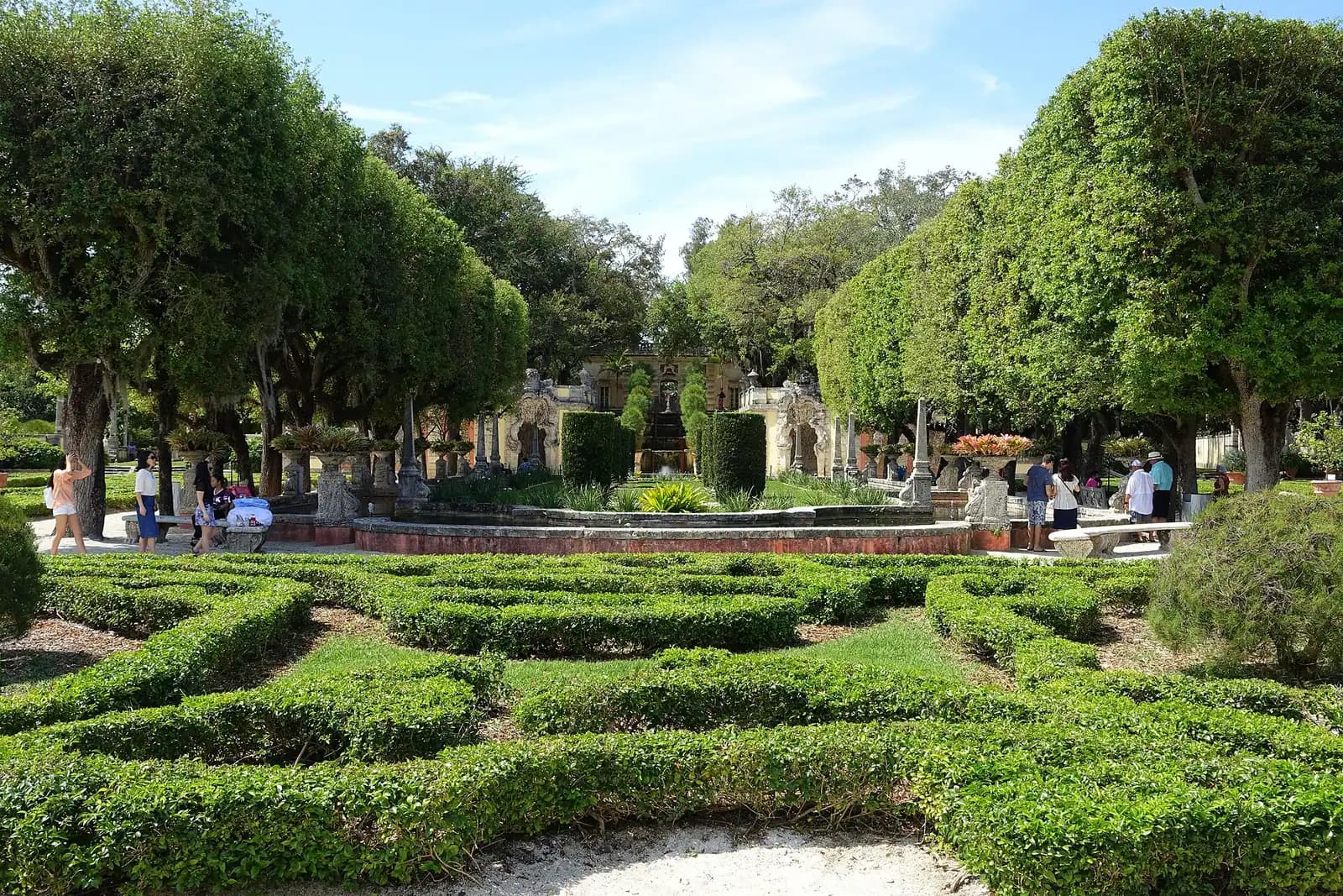 The east facade of an Italianate villa facing across formal terraces to open water